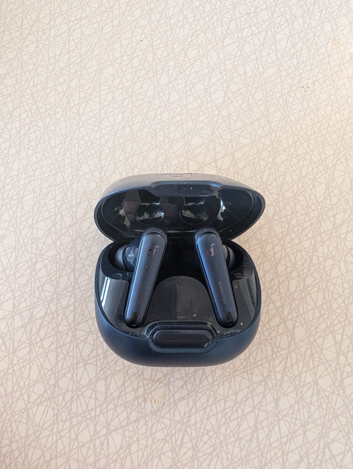 Anker Soundcore Liberty 4 NC earbuds and charging case on a desk