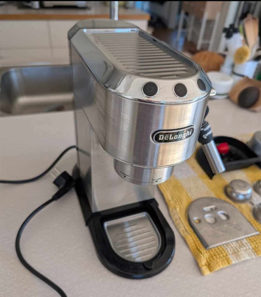 De'Longhi Dedica EC685 espresso machine in metal, compact footprint on kitchen counter
